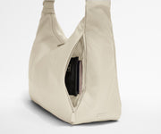 Passport shown in the travel-ready pocket in the front zippered pocket