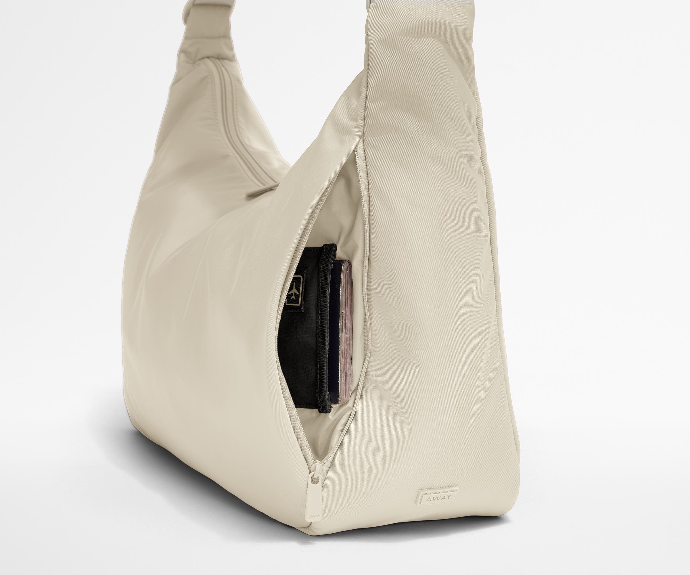 Passport shown in the travel-ready pocket in the front zippered pocket