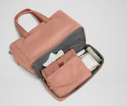 Bottom compartment shown with the included changing pad and Carry-All pouch that fits diapers and wipes