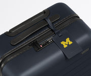 University of Michigan ™ Collegiate Luggage Tag on a matching Collegiate Bigger Carry-On suitcase