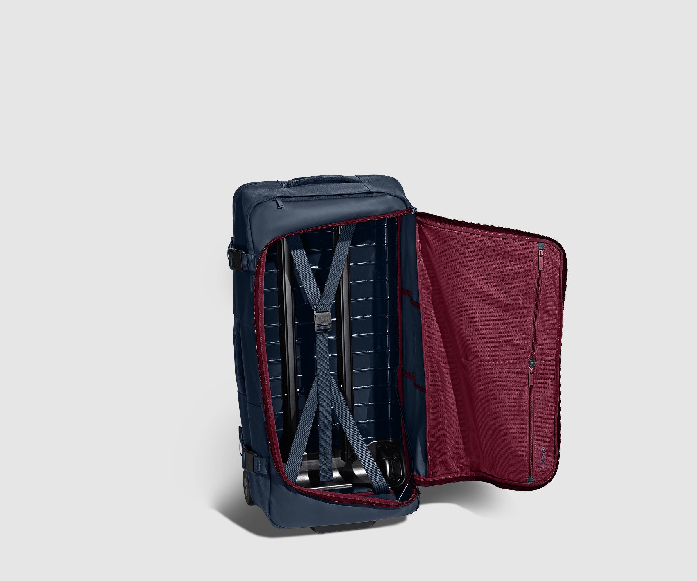 85L Duffle standing upright and unzipped, showing the compression straps and interior pockets
