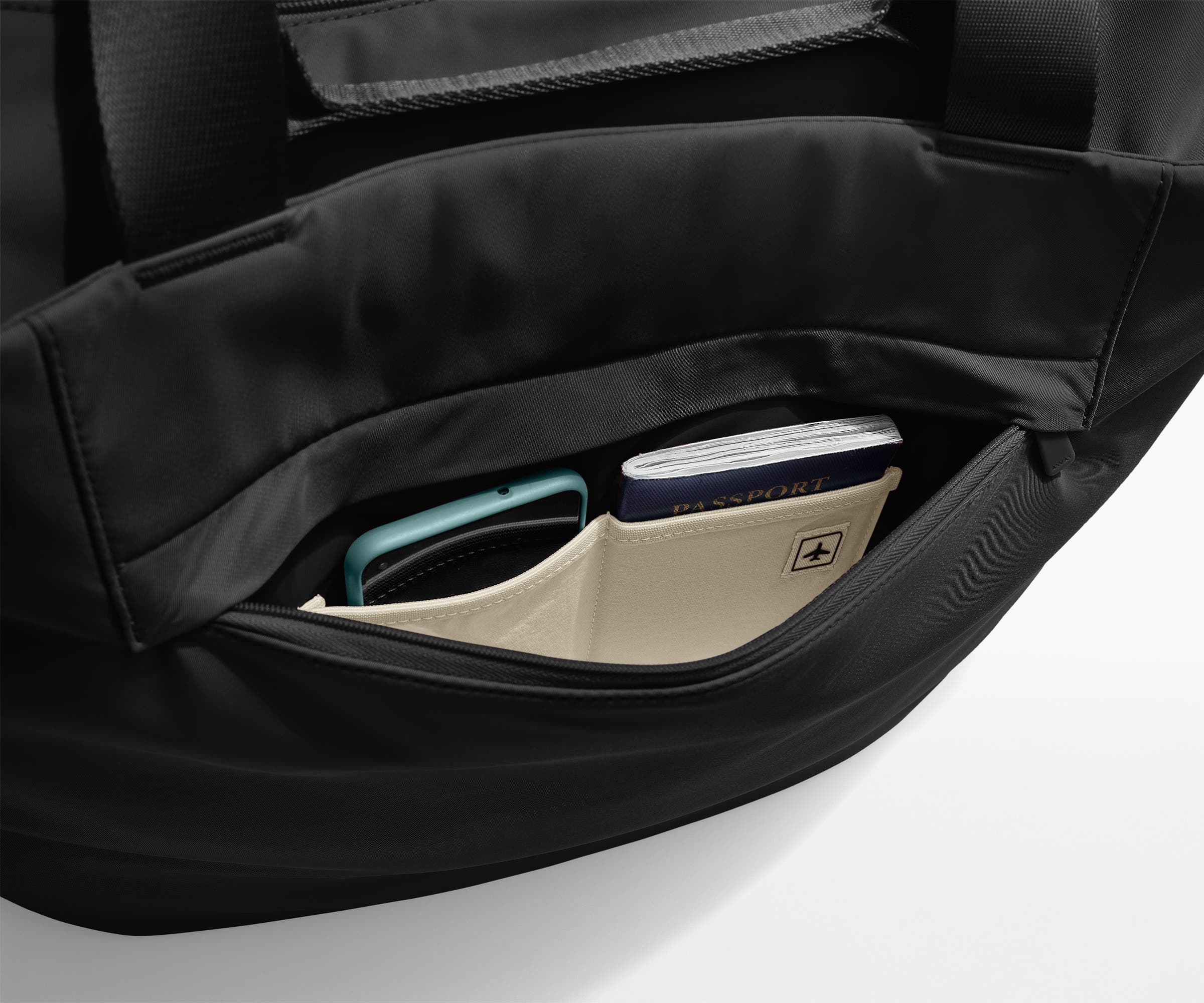 Phone and passport packed in an exterior zip pocket