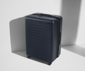 Angled product view of The Large Flex suitcase in Navy Blue