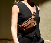 Person wearing the Featherlight Sling Bag in Amaro Brown