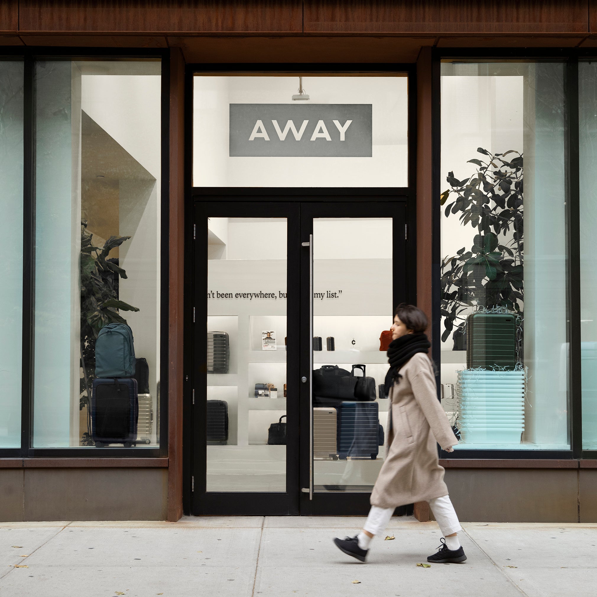 Person walking in front of an Away store