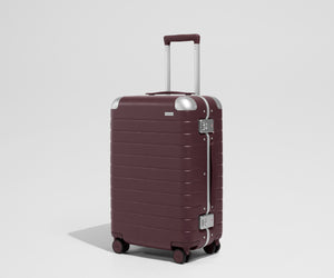 The Aluminum Edge Bigger Carry-On in Oxblood Red