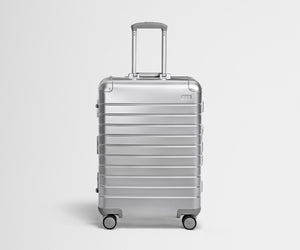 Front view of the Medium: Aluminum suitcase in Silver with handles raised