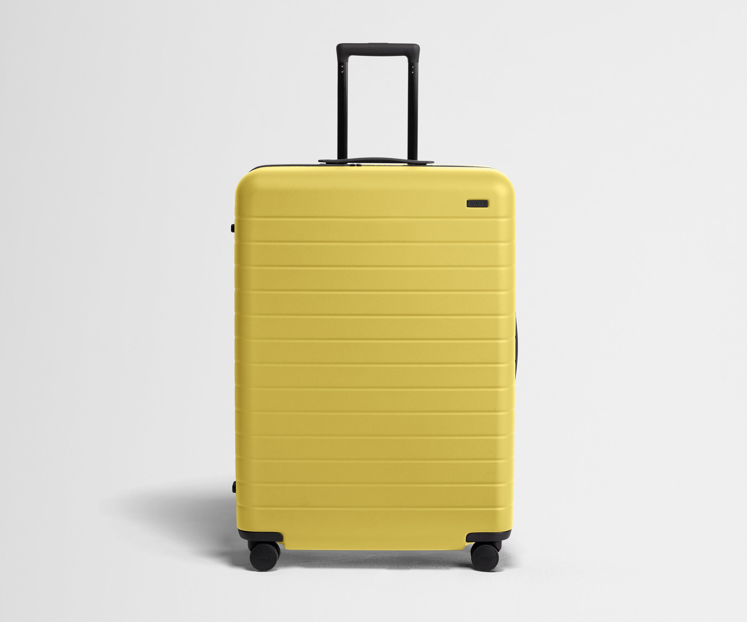 Front product view of The Large suitcase in Sunshine Yellow with raised handle