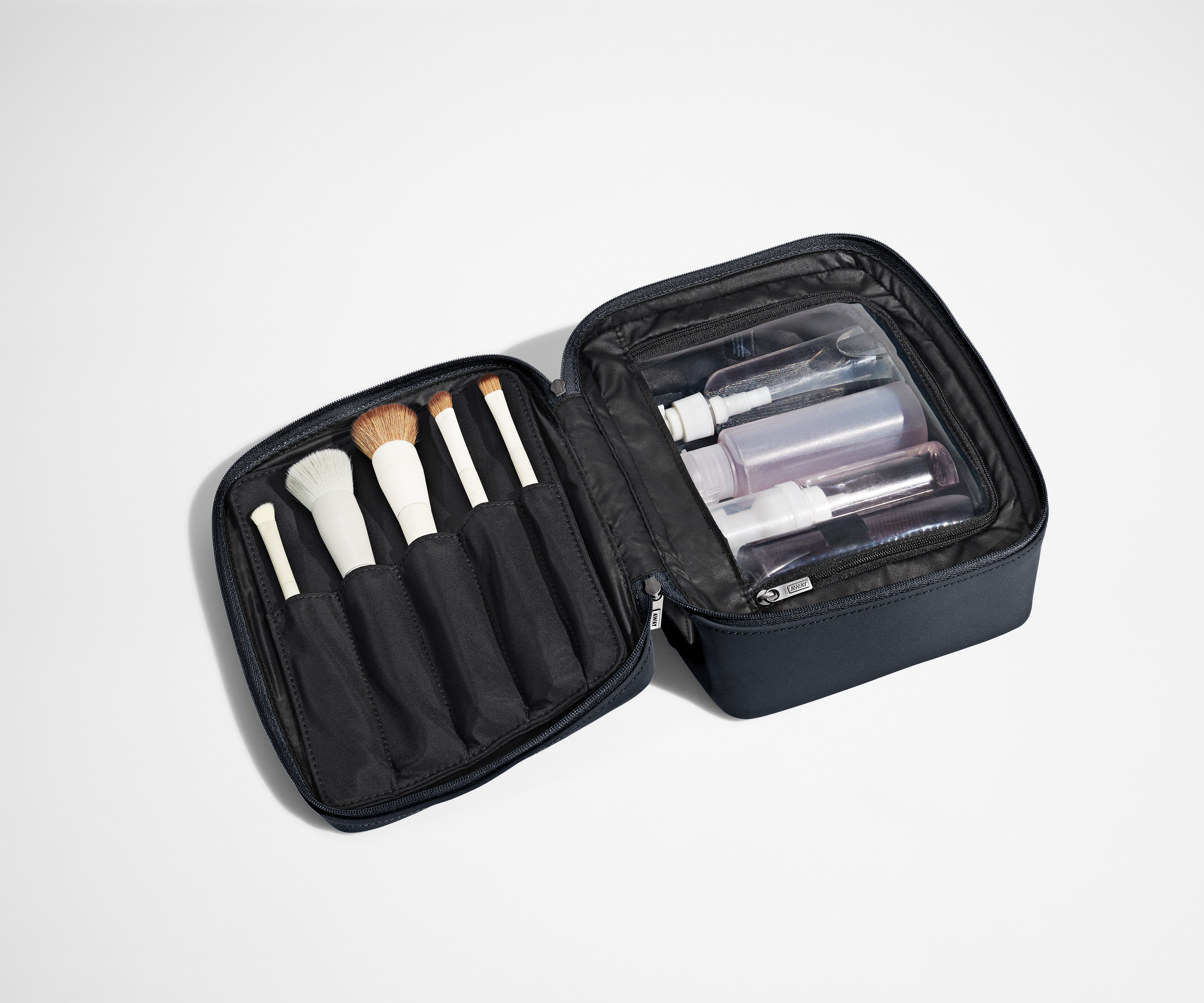 Cosmetics Bag packed with make up brushes and skincare
