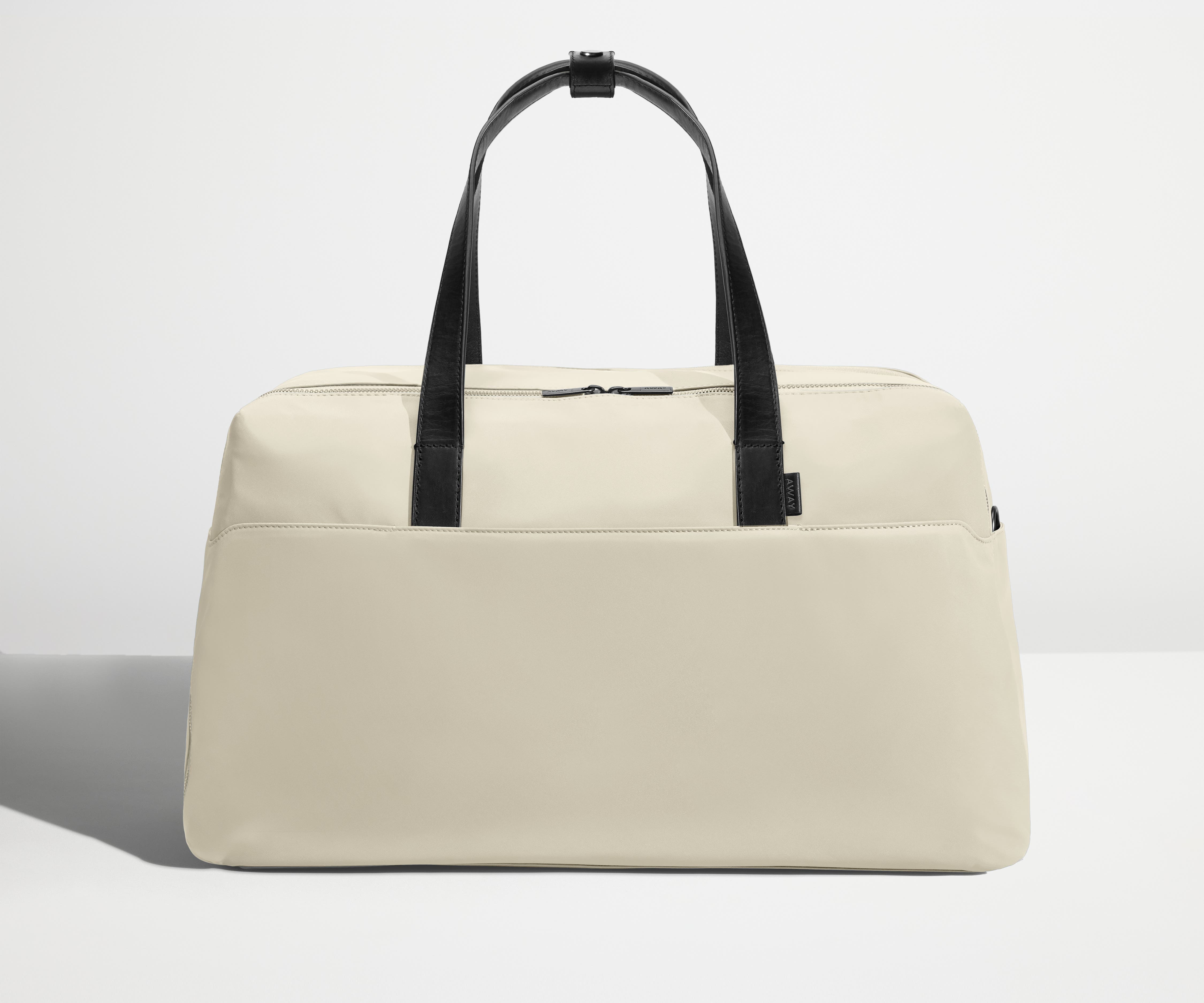 Front view of Away's Weekender duffle in Salt White with handles up