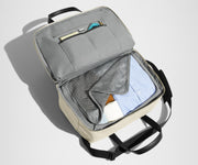 Main interior packed with clothing. Slip pockets packed with a notebook and charging cords