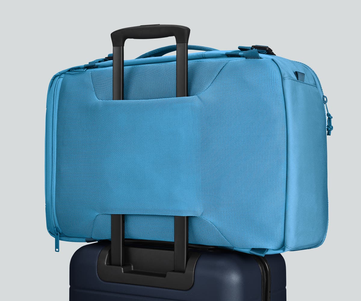 Active Convertible Backpack 45L secured to an Away suitcase by the luggage trolley sleeve