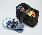 Active Tote 45L packed with clothing, hiking boots, helmet, and other outdoor gear