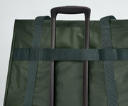 Active Tote 45L secured to an Away suitcase by its trolley strap