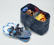 Active Tote 45L packed with clothing, hiking boots, helmet, and other outdoor gear