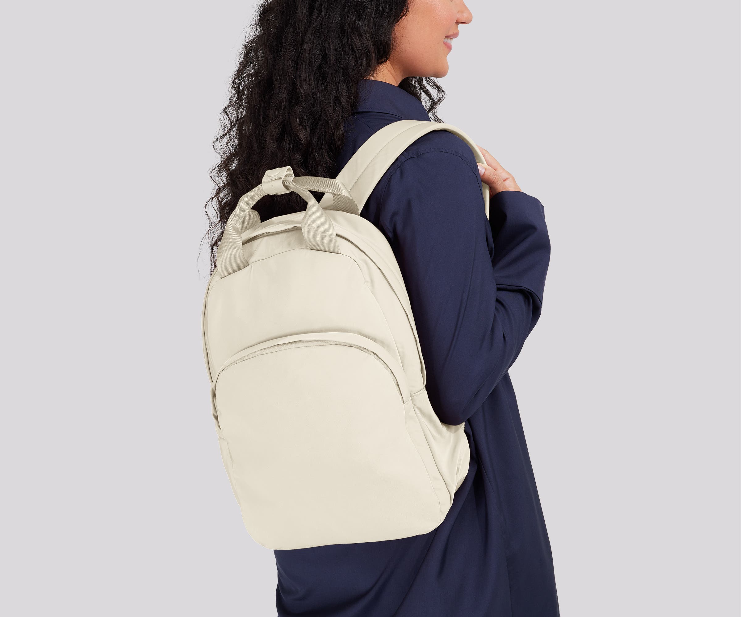 Person wearing the Featherlight Backpack on one shoulder