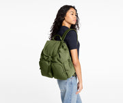 Person wearing a green backpack on a white background