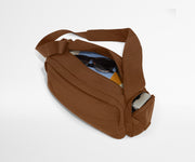 Featherlight Cargo Pack packed with notebooks, sunglasses, and a camera