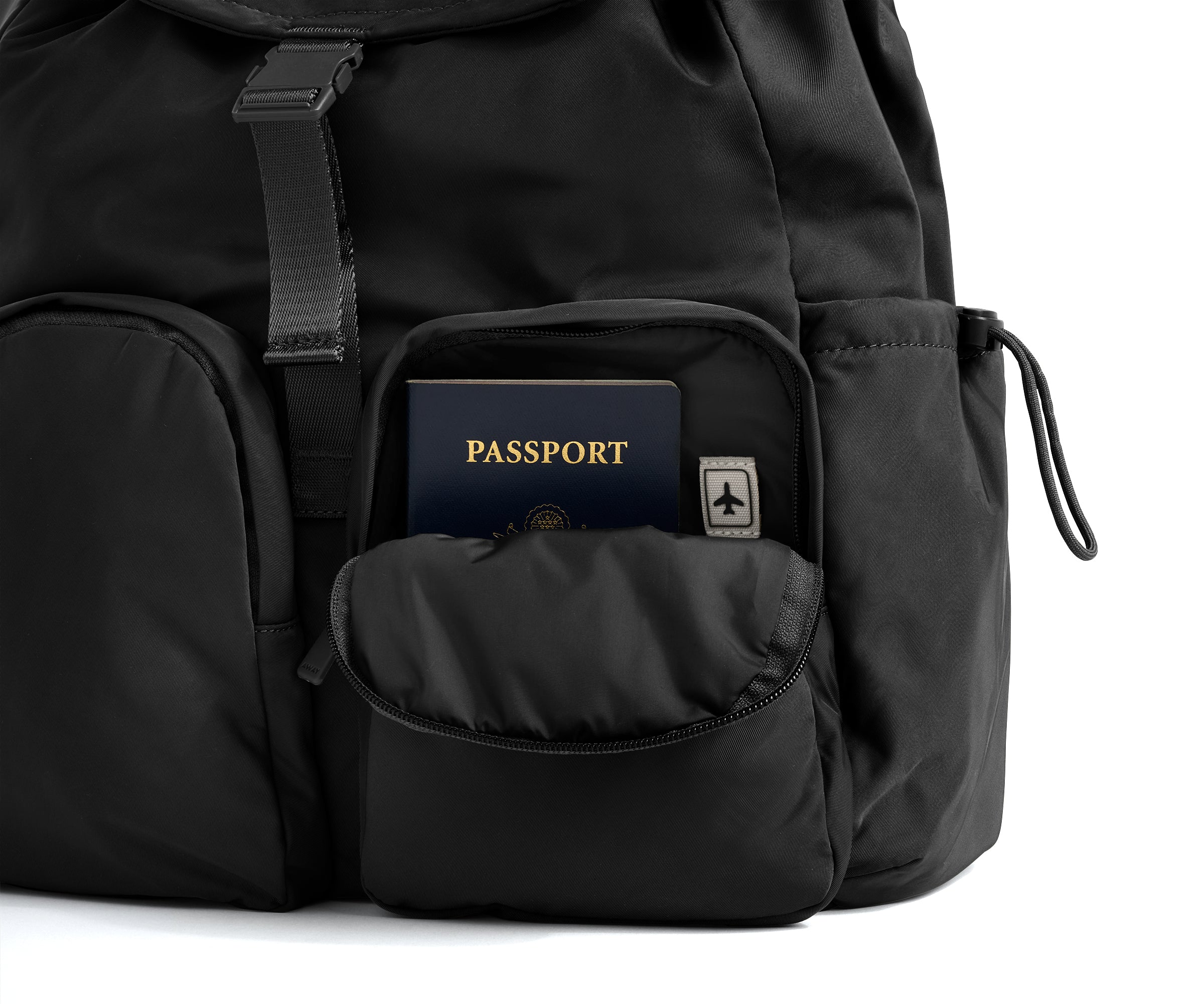 Black backpack with a passport in a pocket on a white background