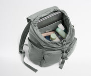 Gray backpack with items inside on a white background