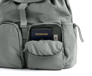 Gray backpack with a passport in an open pocket on a white background