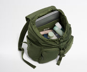 Green backpack with items inside on a white background