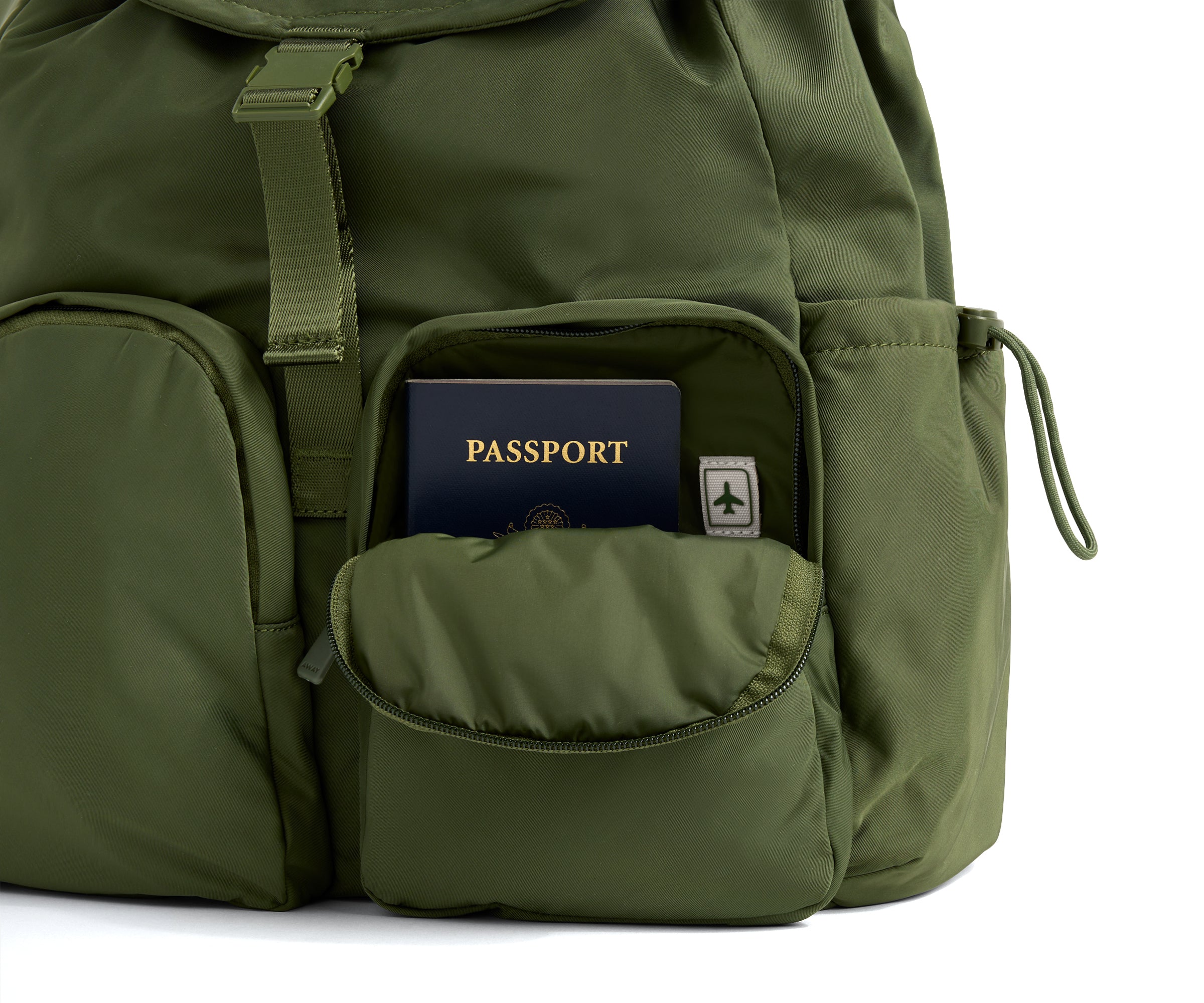 Green backpack with a passport in an open pocket on a white background