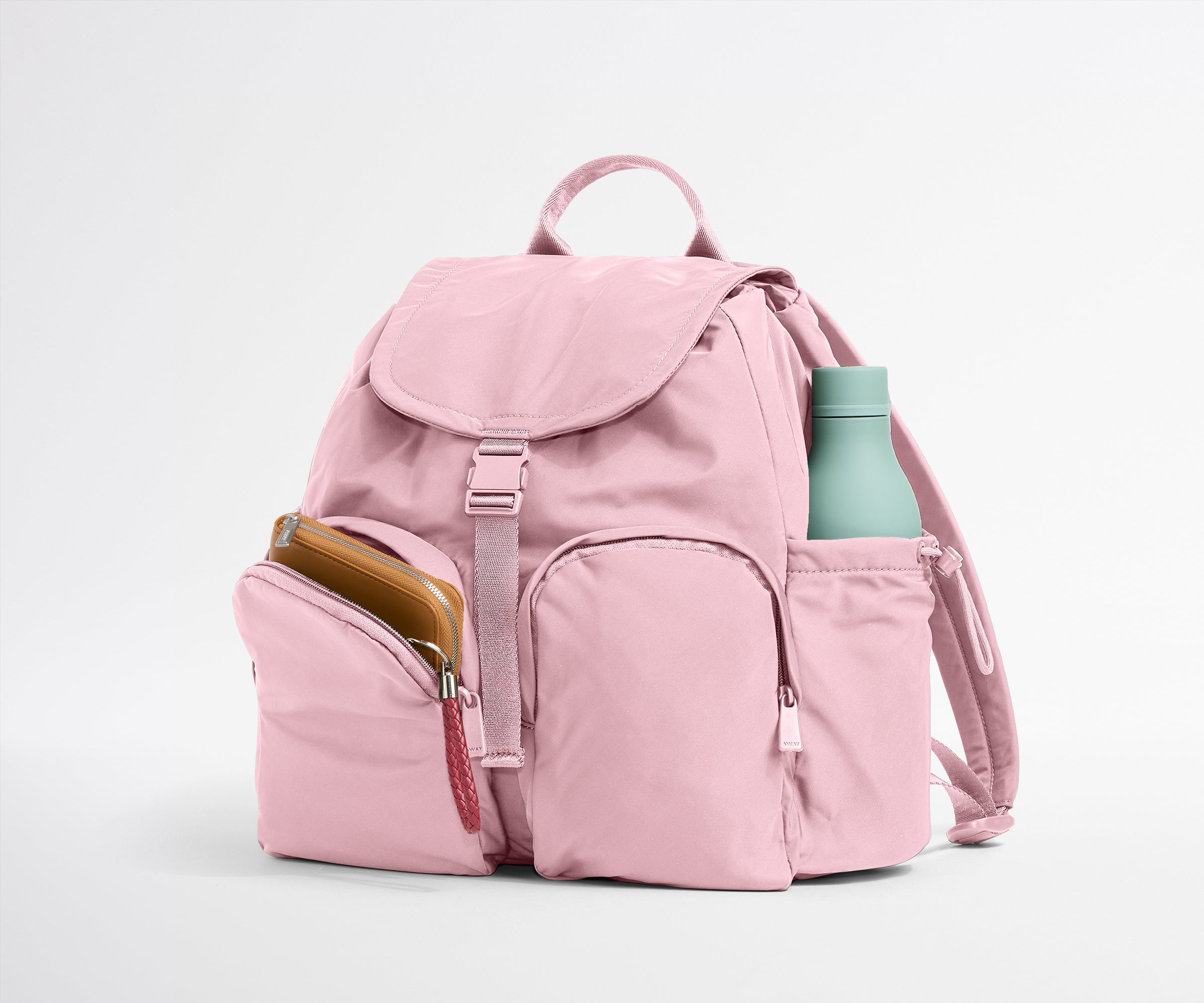 Pink backpack with a water bottle on a light gray background