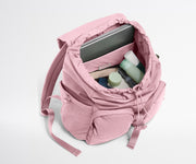 Pink backpack with items inside on a white background