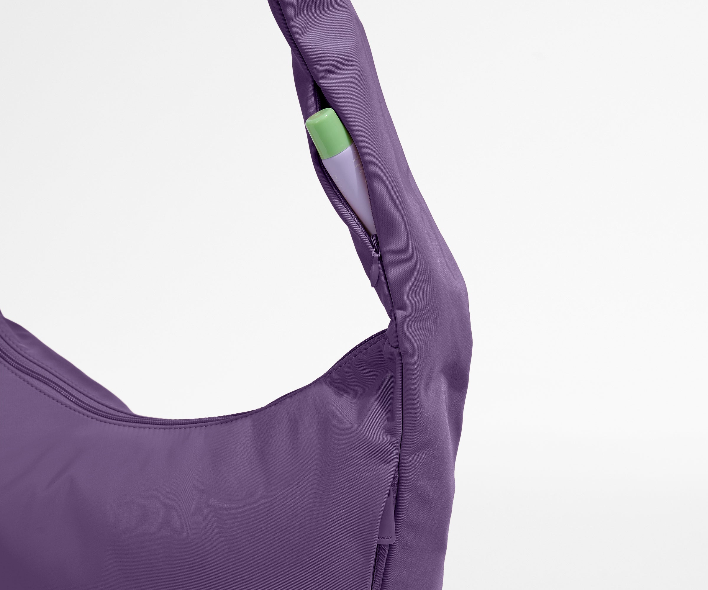 Chapstick in the discreet, zippered strap pocket