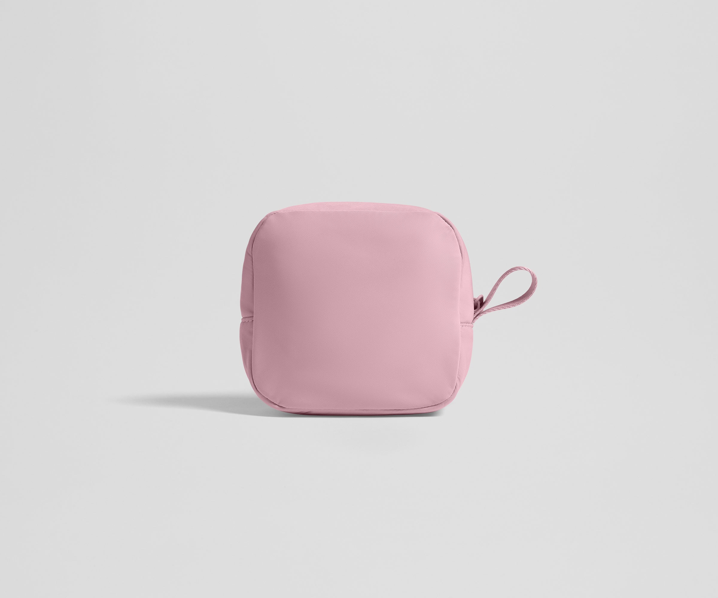 Pink tech pouch on a light gray background