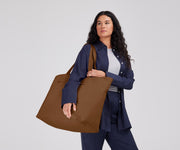 Person wearing the Large Featherlight Tote on their shoulder using the longer shoulder straps