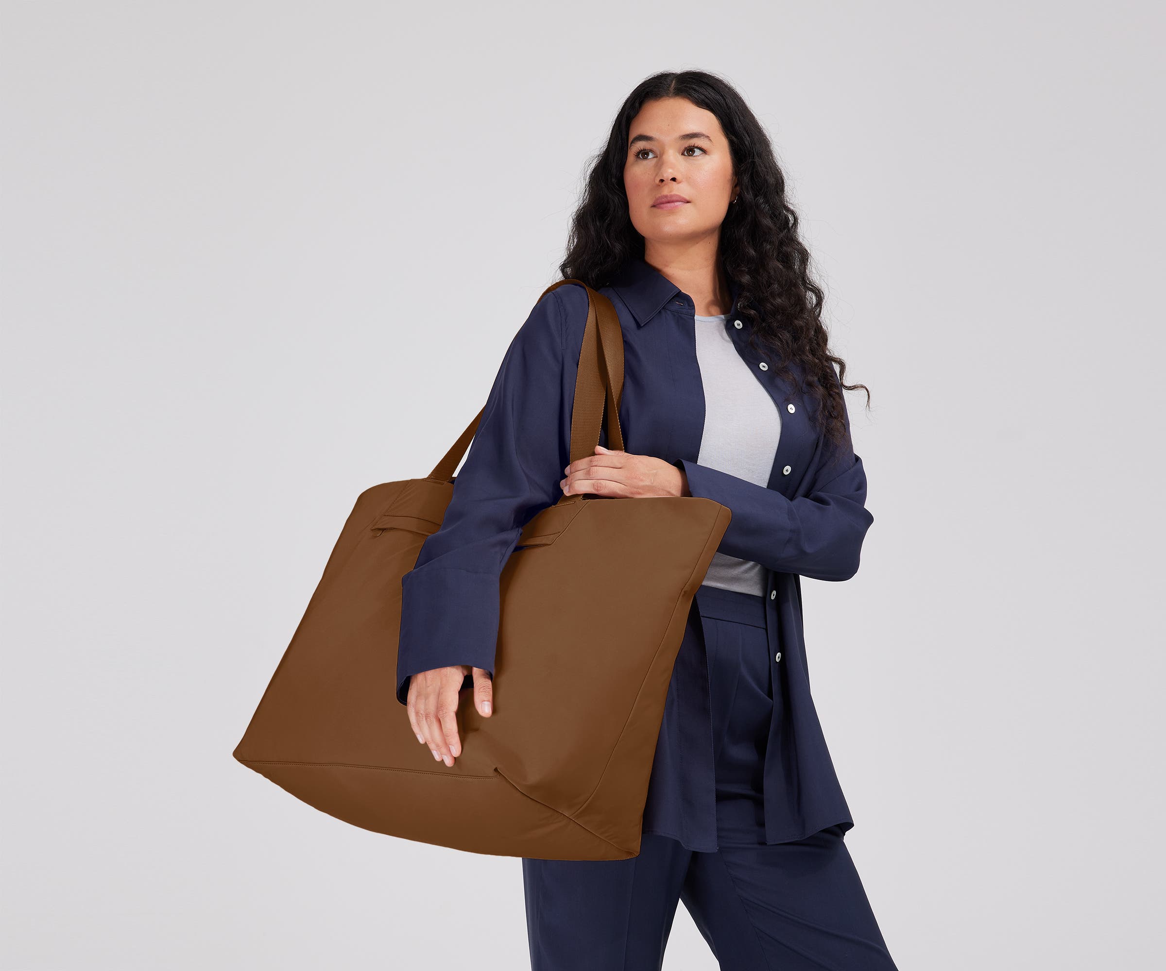 Person wearing the Large Featherlight Tote on their shoulder using the longer shoulder straps