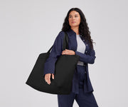 Person wearing the Large Featherlight Tote on their shoulder using the longer shoulder straps