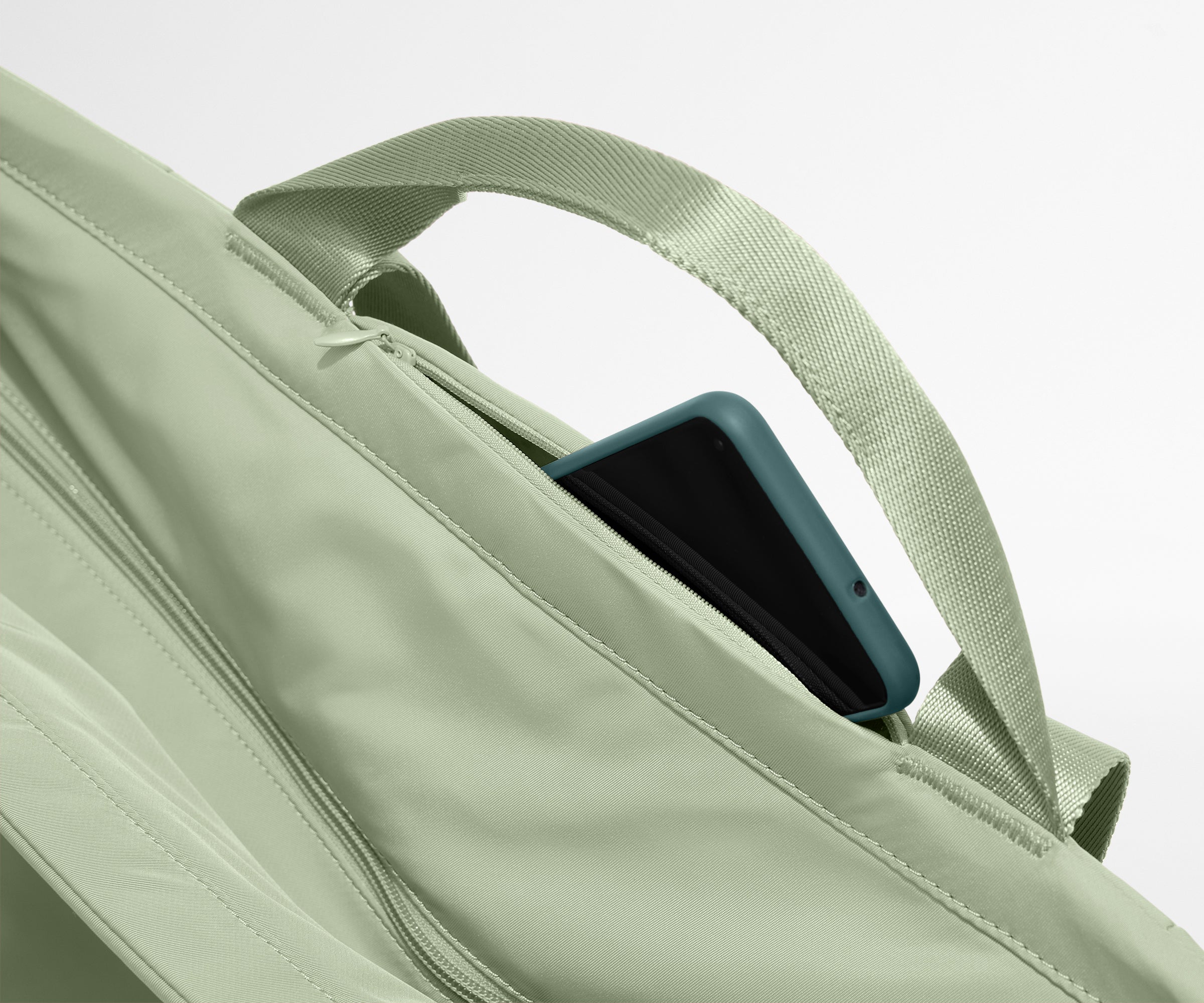 Phone shown in the hidden pocket between handles