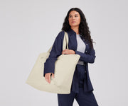 Person wearing the Large Featherlight Tote on their shoulder using the longer shoulder straps
