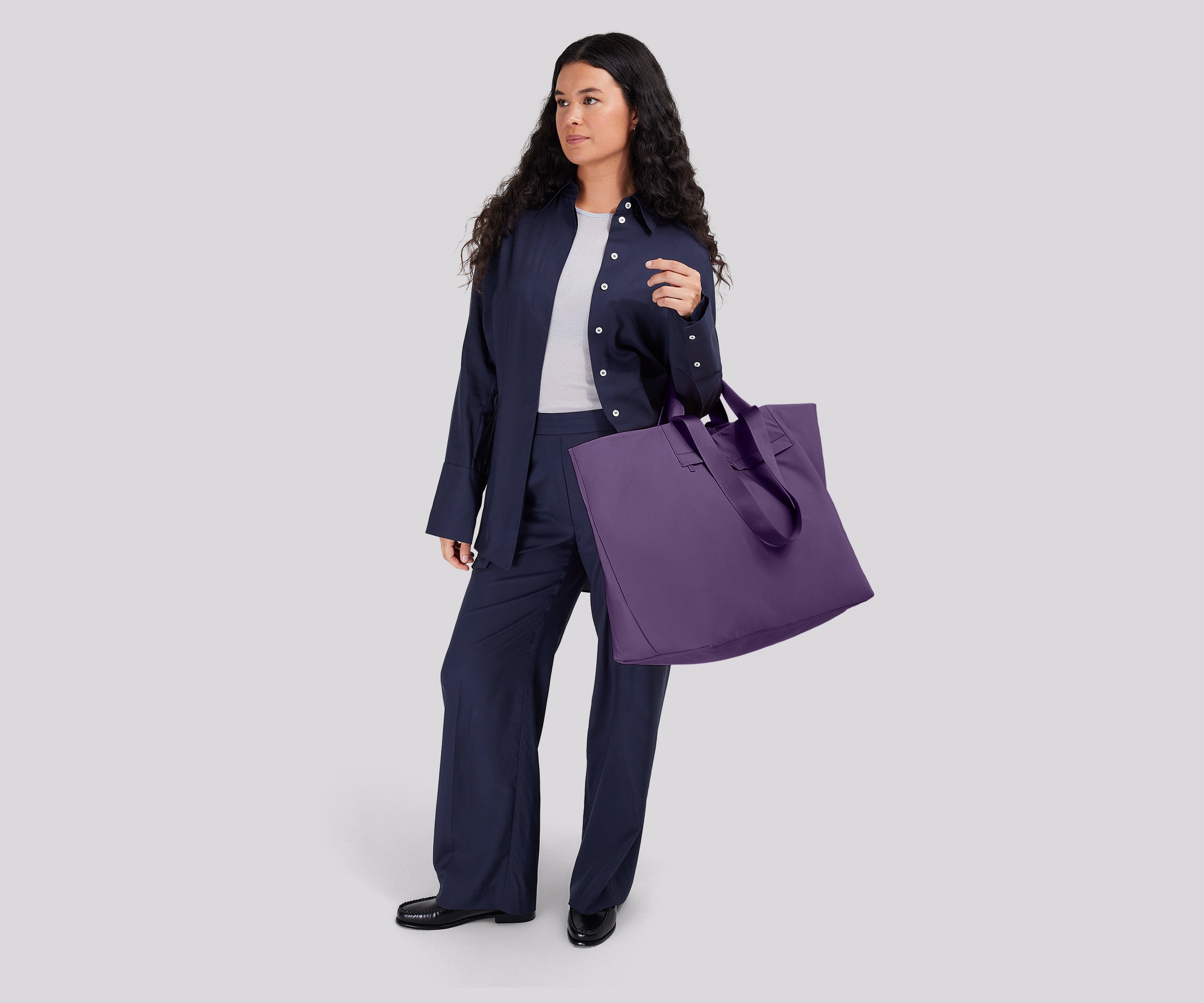 Person wearing the Large Featherlight Tote on their shoulder using the longer shoulder straps