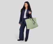Person wearing the Large Featherlight Tote on their shoulder using the longer shoulder straps