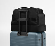 Featherlight Weekender shown on top of an Away suitcase