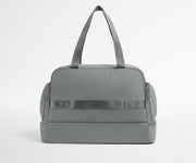 Gray duffel bag on a light gray background