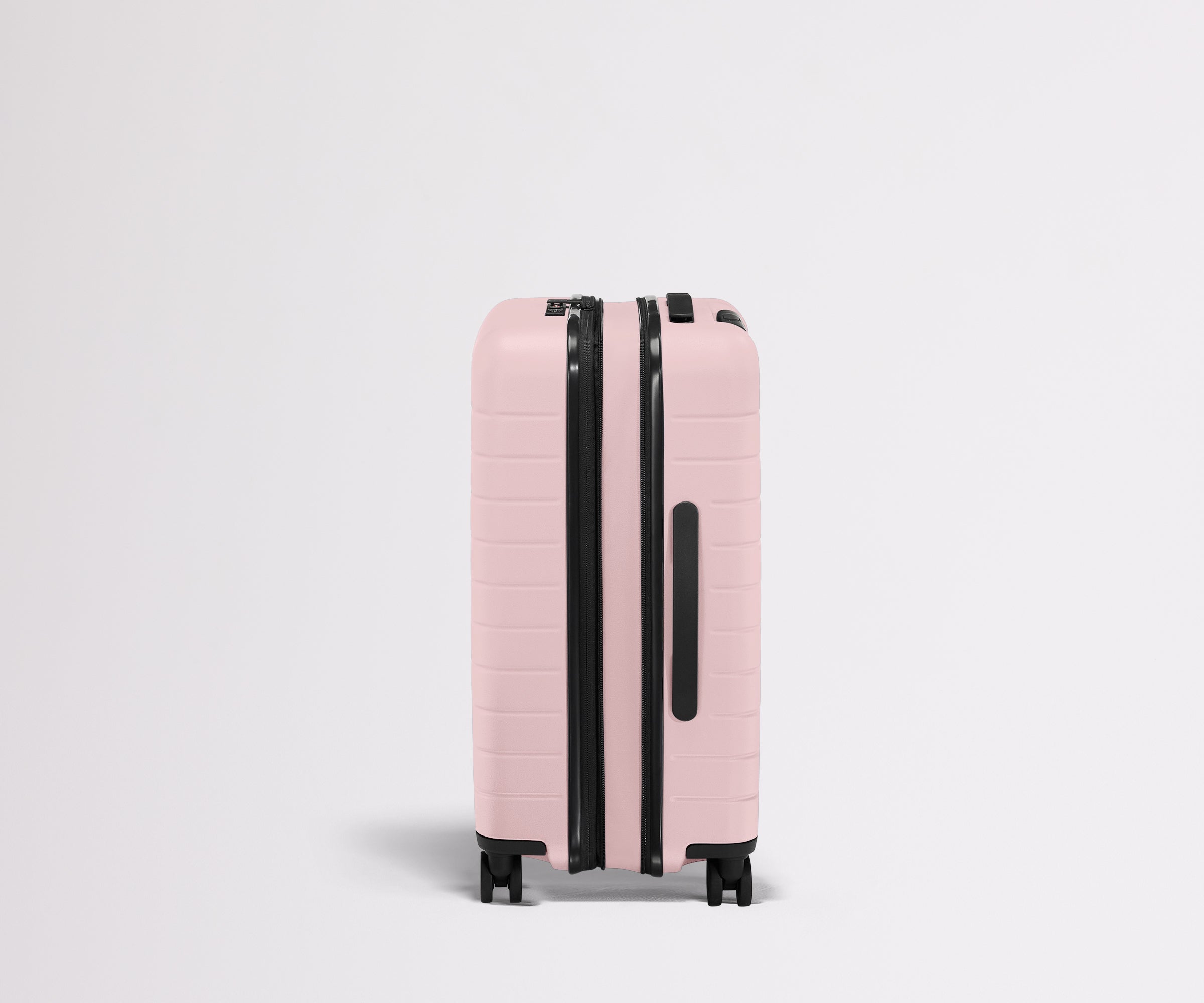 Side product view of The Bigger Carry-On Flex suitcase in Blush Pink shown fully expanded