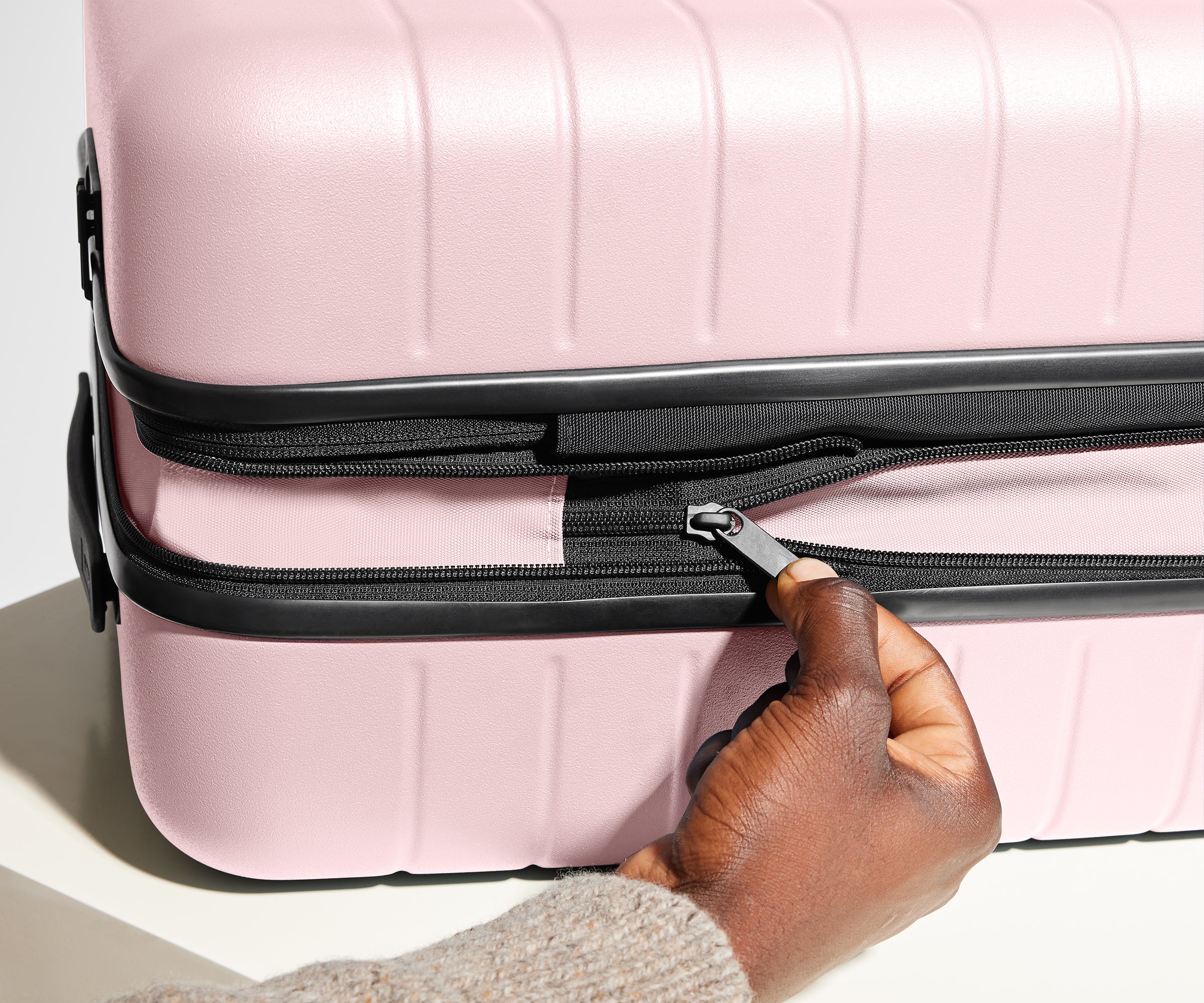 Hand unzipping the additional wraparound expansion feature