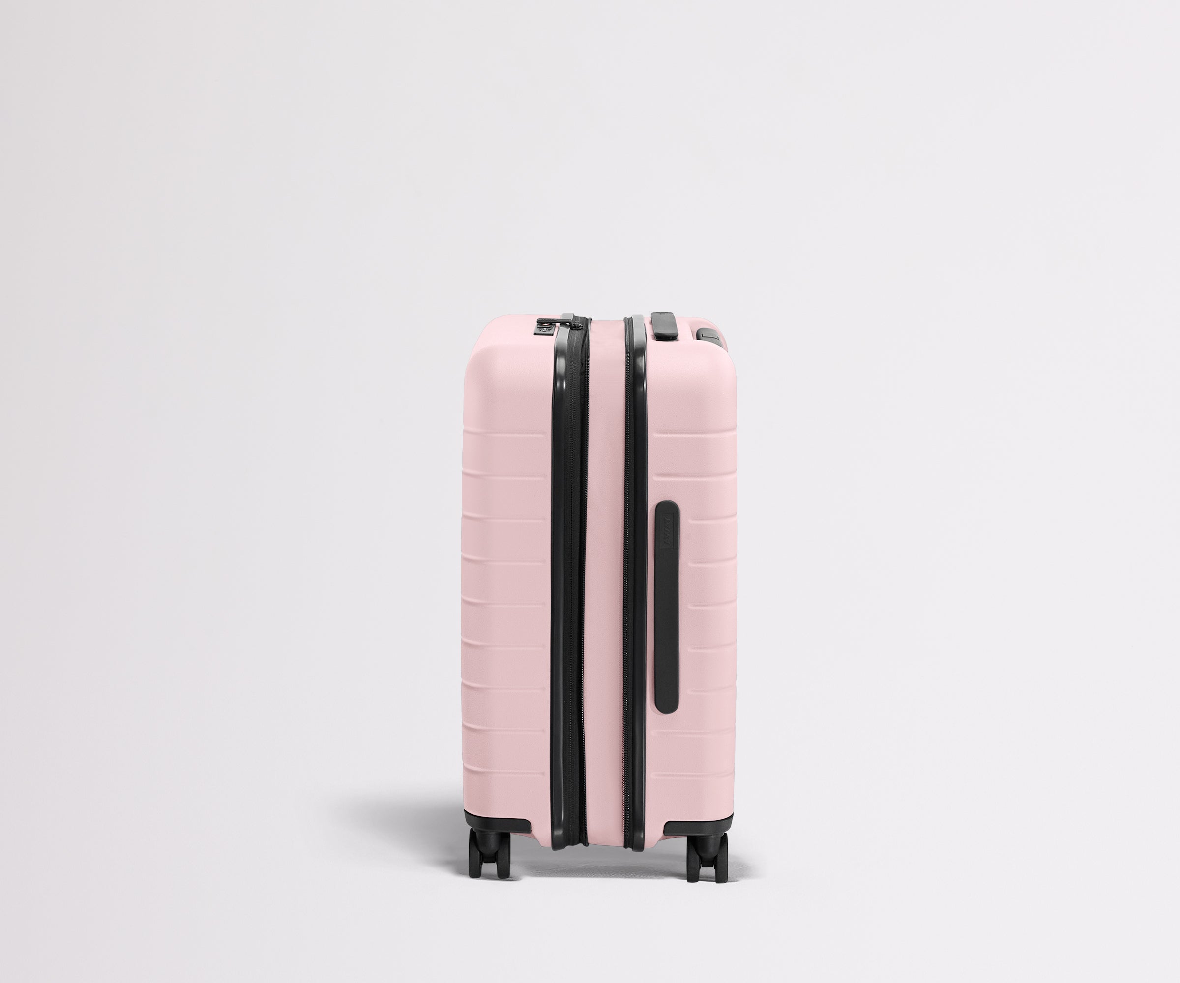 Side product view of The Carry-On Flex suitcase in Blush Pink shown fully expanded