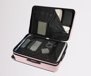The Large Flex suitcase in Blush Pink shown open on its side and packed with Away's packing organizers to show capacity and the interior compression system, designed to help you pack more in