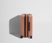 Side product view of The Carry-On Flex suitcase in Clay Pink shown fully expanded