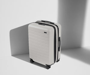 Angled product view of The Bigger Carry-On Flex suitcase in Cloud Gray