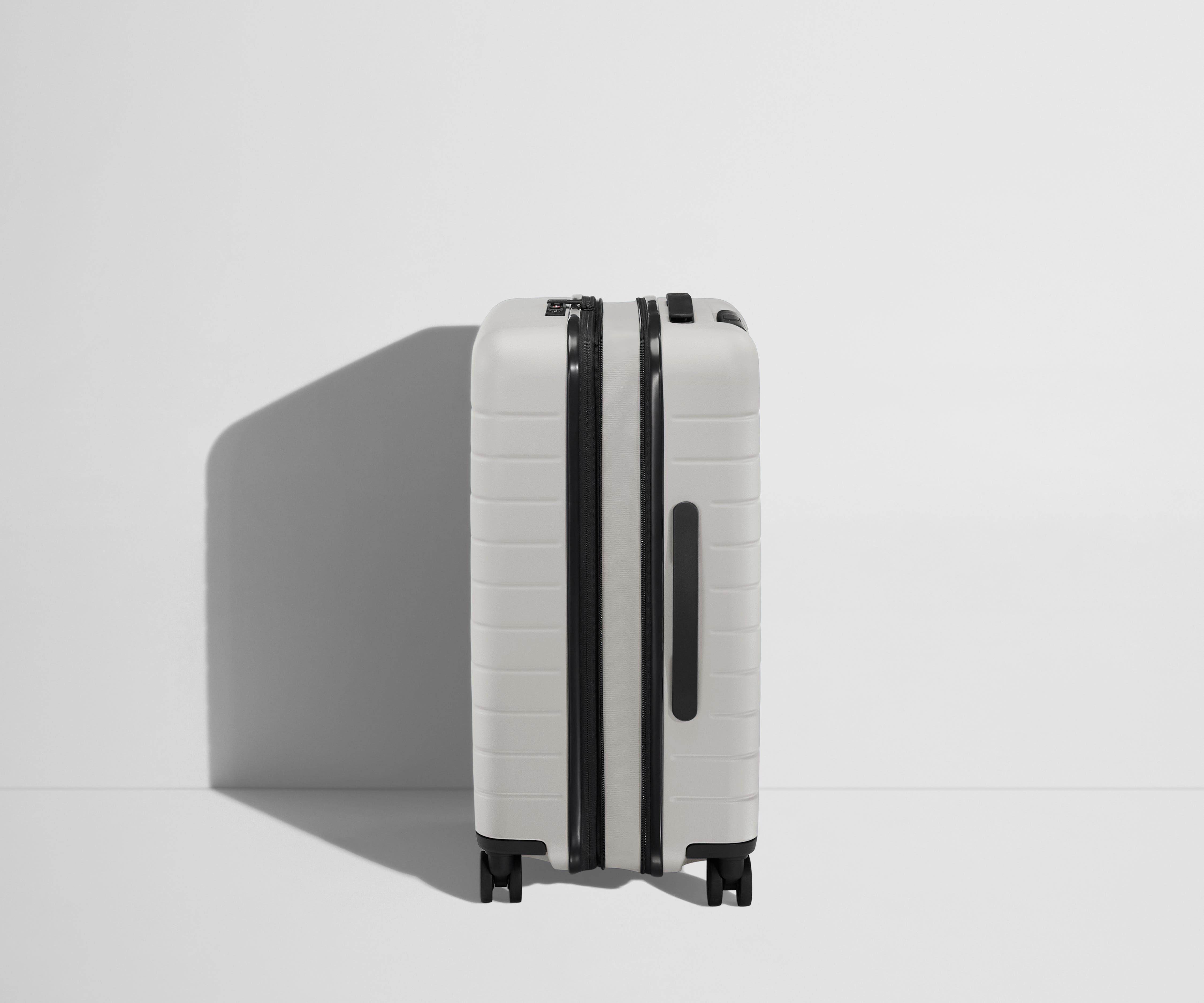 Side product view of The Bigger Carry-On Flex suitcase in Cloud Gray shown fully expanded