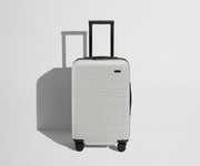 Front product view of The Carry-On Flex suitcase in Cloud Gray with raised handle