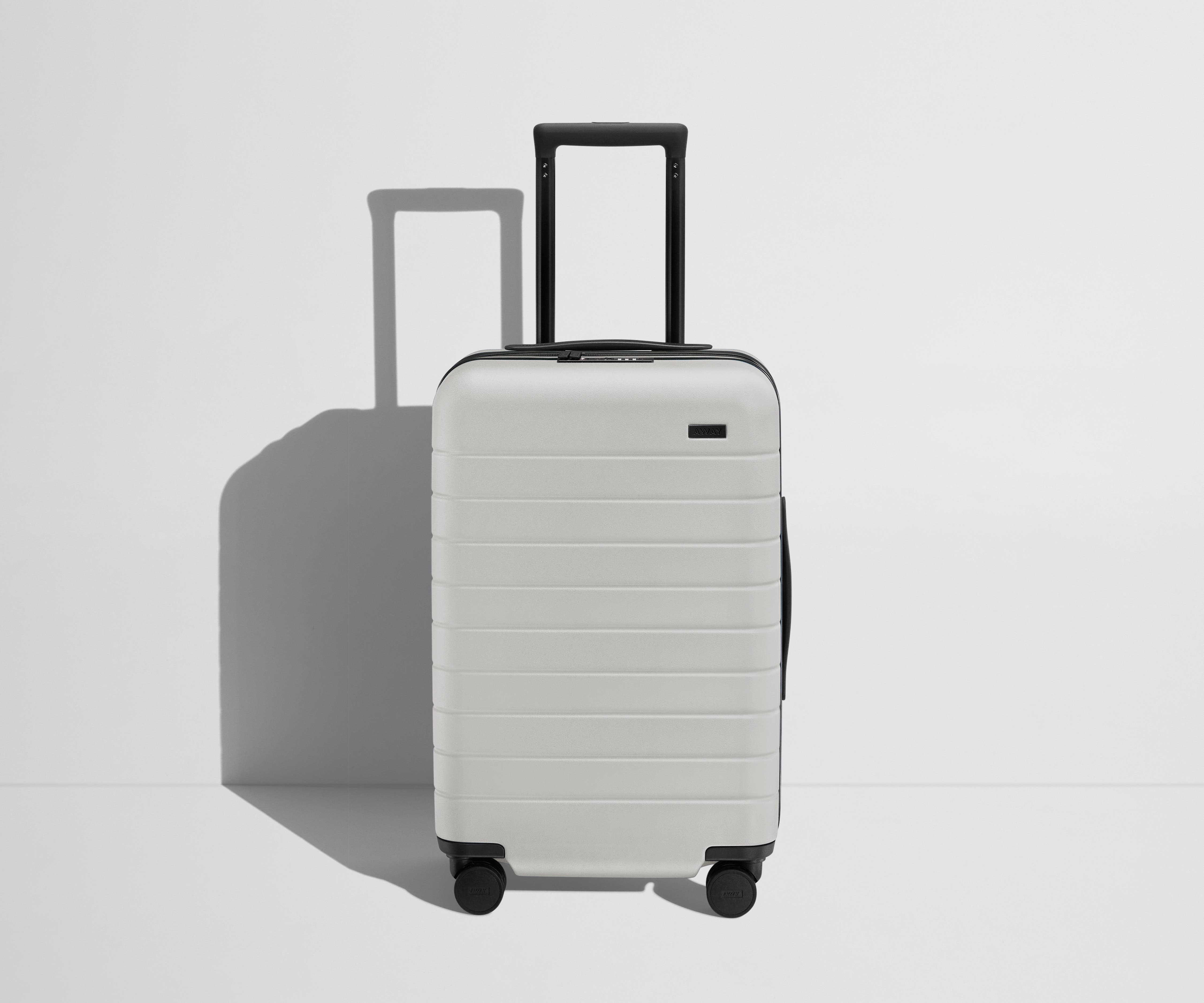 Front product view of The Carry-On Flex suitcase in Cloud Gray with raised handle