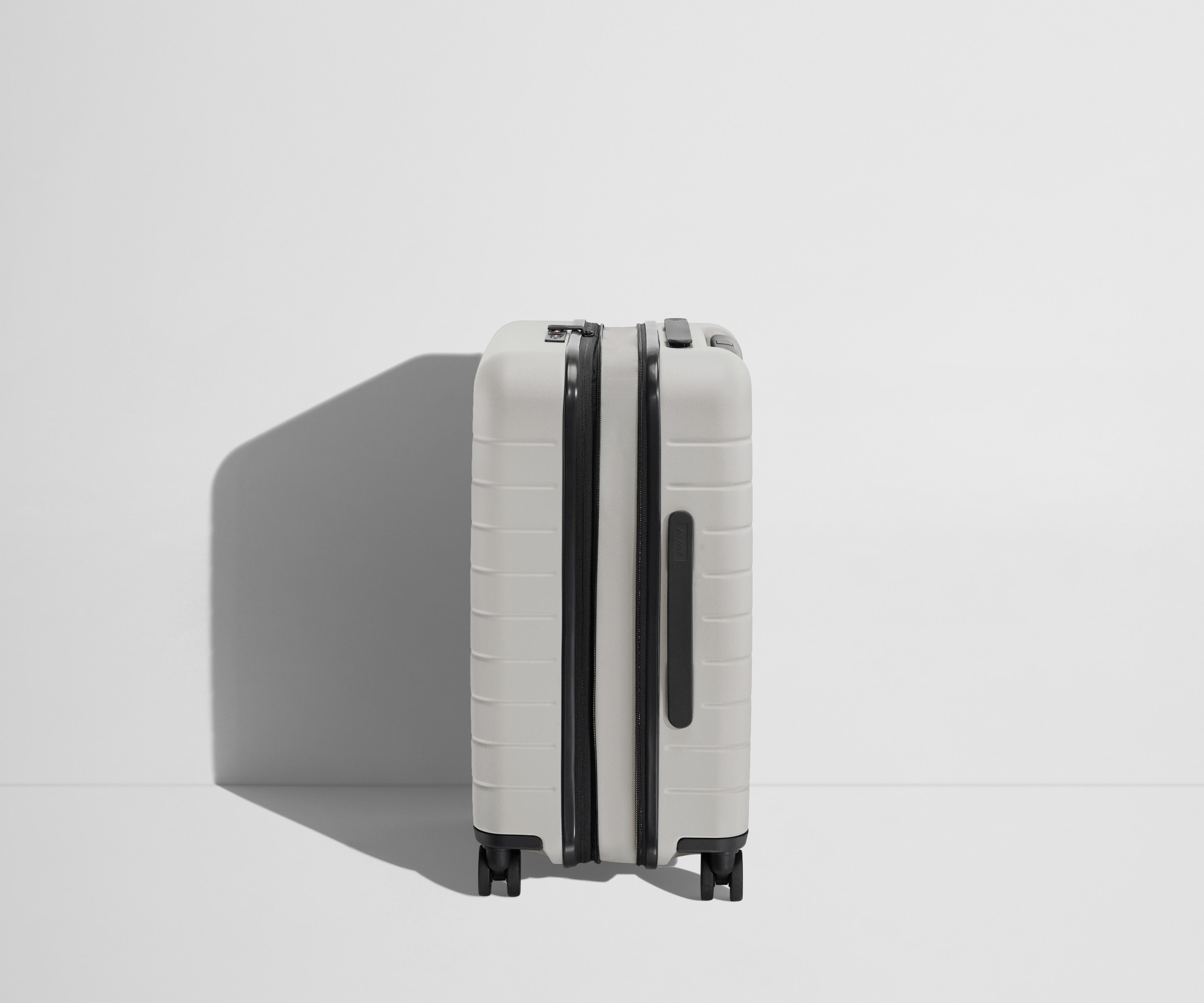 Side product view of The Carry-On Flex suitcase in Cloud Gray shown fully expanded